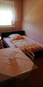 a bedroom with two beds and a table and a window at Ferienwohnung Mücheln 1 in Mücheln