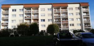 a large apartment building with cars parked in front of it at Ferienwohnung Mücheln 1 in Mücheln +4 photos