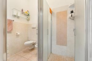 a bathroom with a toilet and a shower stall at Casa Susanna in Calasetta +20 photos