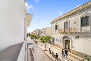 a group of people walking down a street at Casa Susanna in Calasetta