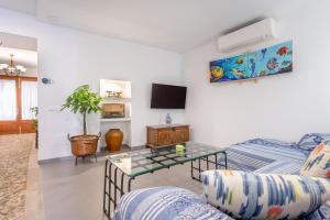a living room with a couch and a tv at Cas Solleric in Petra