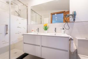 a white bathroom with a sink and a mirror at Cas Solleric in Petra +19 photos