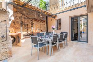 a dining room with a table and chairs at Cas Solleric in Petra