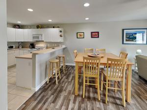 a kitchen and dining room with a table and chairs at Lazy Daze in Surf City