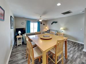 a dining room and living room with a table and chairs at Lazy Daze in Surf City +21 photos