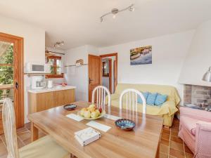 a kitchen and a living room with a table at Es Romaní in Cala Ratjada +17 photos