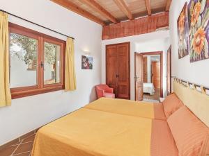 a bedroom with two beds and a window at Es Romaní in Cala Ratjada