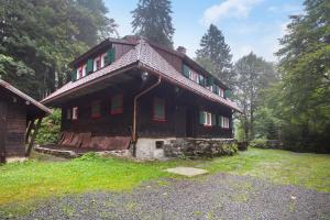 a large wooden house in the middle of a field at Zähringer Hütte in Feldberg