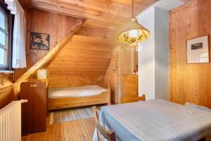 a room with a bed and a staircase in a house at Zähringer Hütte in Feldberg