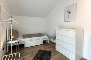 a small bedroom with a bed and a desk at Schmuckstück in Hilzingen