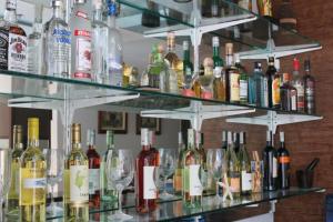 a shelf full of wine bottles and glasses at Boracay Haven Suites in Boracay