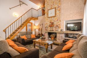 a living room with two couches and a fireplace at Ca na Rossa in Campanet