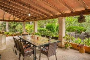 an outdoor patio with a table and chairs at Ca na Rossa in Campanet