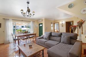 a living room with a couch and a table at Villa Guisado in Albufeira