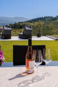 a bottle of wine sitting on a table with two wine glasses at Corner 28 in Oberkirch