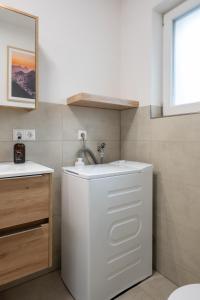 a white bathroom with a sink and a mirror at Corner 28 in Oberkirch +33 photos