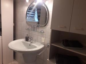a white bathroom with a sink and a mirror at Ferienwohnung Köppl in Lam +12 photos