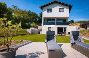 two chairs on a patio in front of a house at Corner 28 in Oberkirch