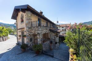 a stone house with a balcony on a street at Casa Rita app 4 in Tremosine Sul Garda