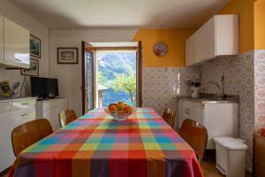 a kitchen with a table with a bowl of fruit on it at Il Melo in Trasquera