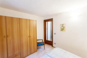 a bedroom with a bed and a wooden cabinet at Casa Rita app 4 in Tremosine Sul Garda