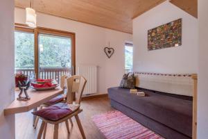a living room with a couch and a table at Huberhof App Gala in Feldthurns +21 photos