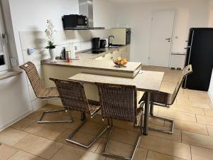 a kitchen with a table and chairs in a room at Ferienwohnung Oleander in Dresden