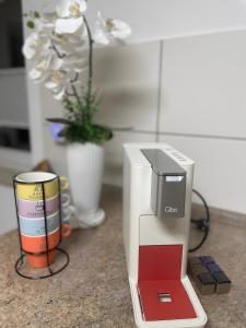 a coffee maker sitting on a counter next to a cup at Ferienwohnung Oleander in Dresden