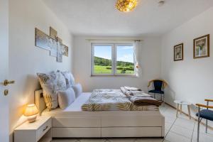 a bedroom with a bed and a window at Apartment Ayleen in Boll