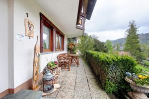 a small patio with a table and chairs on a house at Haus Kurparkblick in Todtmoos