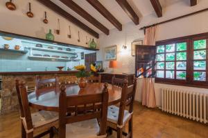 a dining room with a wooden table and chairs at Cuixach villa in Pollensa with Wifi in Pollença