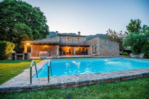 an estate with a swimming pool in front of a house at Cuixach villa in Pollensa with Wifi in Pollença