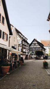 a cobblestone street in a town with black and white buildings at Hochburger 21 in Emmendingen +13 photos