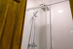 a shower in a bathroom with a glass door at Pio in Tremp
