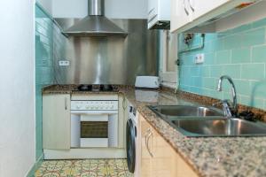 a kitchen with a sink and a stove at Pio in Tremp