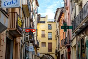 a narrow street in a city with buildings at Pio in Tremp