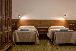 a room with two beds with blankets on them at Pio in Tremp