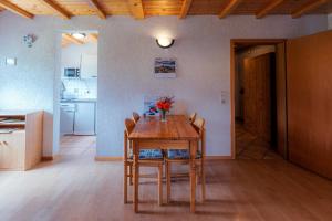 a kitchen and dining room with a wooden table and chairs at Hinterhauensteinhof in Hornberg