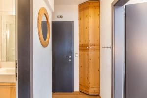 a bathroom with a black door and a mirror at Haus Excelsior Top 37b in Seefeld in Tirol +30 photos