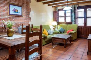 a living room with a couch and a table at Las Puentes 1 in Candelario