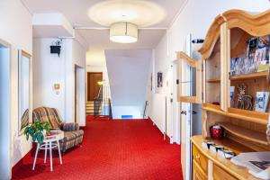 a hallway with a red carpet and a living room at Haus Excelsior Top 37b in Seefeld in Tirol