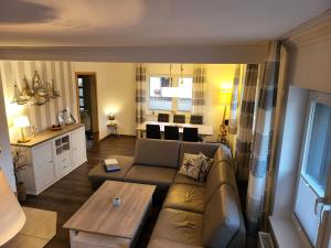 a living room with a couch and a table at Anker Perla in Grömitz