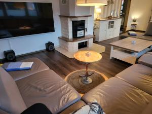 a living room with a couch and a fireplace at Anker Perla in Grömitz +28 photos