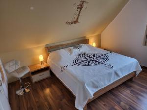 a bedroom with a white bed with aigil on it at Anker Perla in Grömitz
