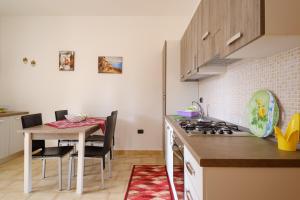 a kitchen with a table and a stove top oven at Villetta del Salento 1 in Racale