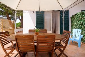 a table and chairs with an umbrella on a patio at Villetta del Salento 1 in Racale