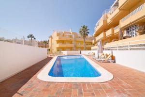 a swimming pool in front of a building at Royal Cabanas Golf 89 in Cabanas de Tavira