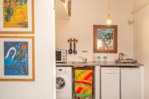 a kitchen with a sink and a washing machine at Vecchio Marino H4 in Palau +16 photos