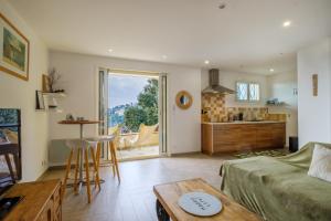 a living room with a couch and a table at Duplex 2 chambres Golden Sun in Théoule-sur-Mer
