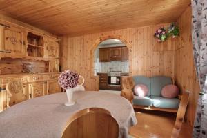 a kitchen with a table and a couch in a room at La Maison du Bonheur Lillaz in Cogne +17 photos